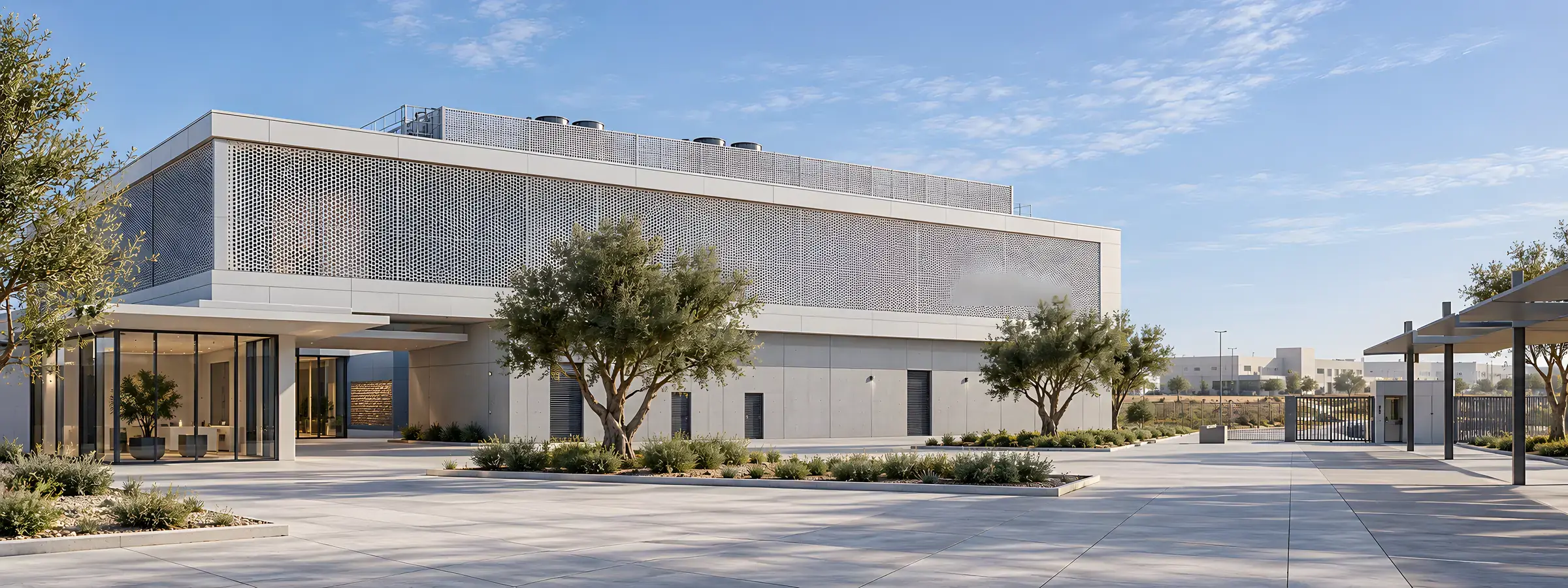 Architectural concept visualisation: a compact data center with a perforated metal screen and a glazed reception pavilion, seen across its courtyard